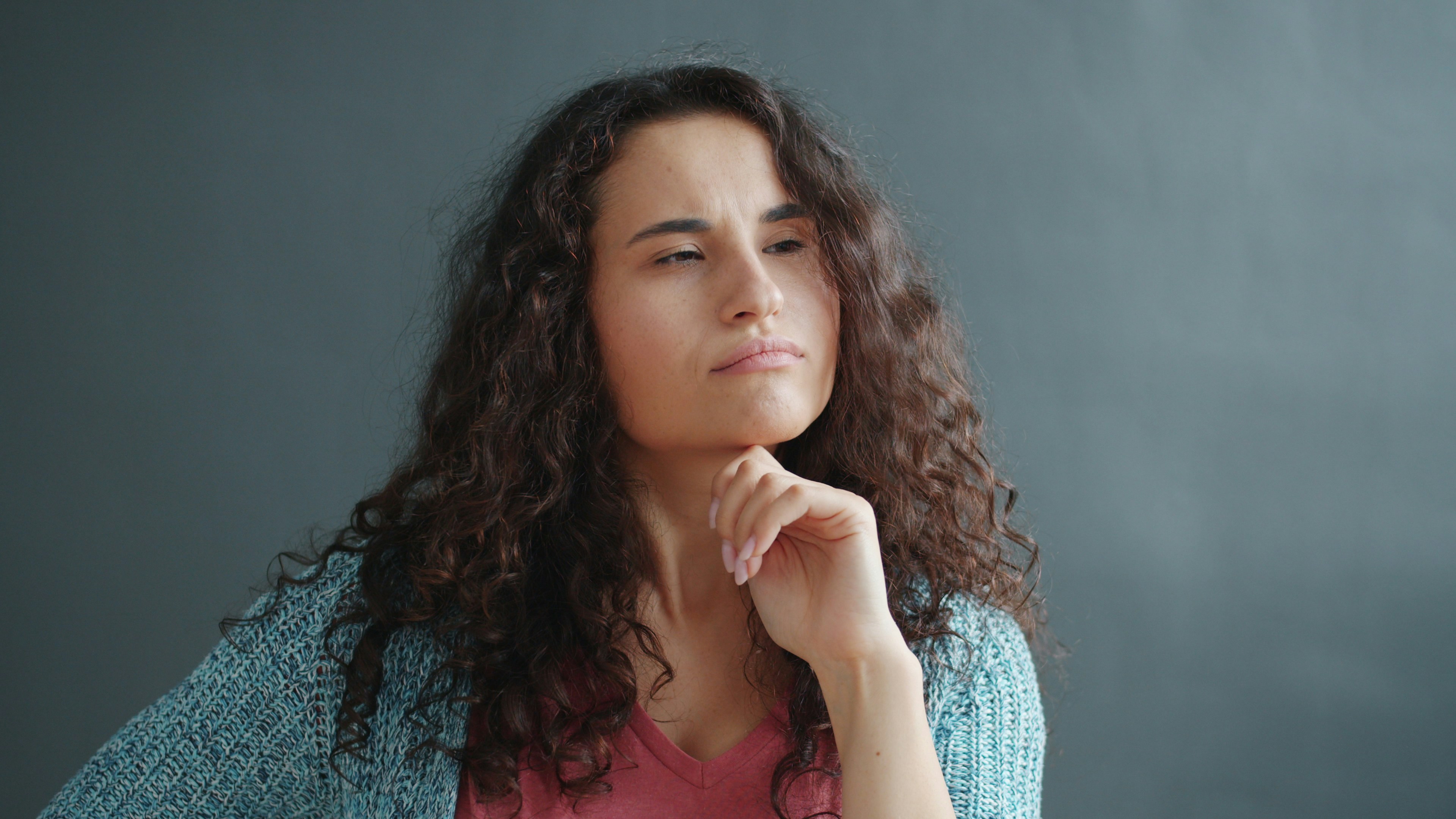 Woman looking thoughtful and uncertain