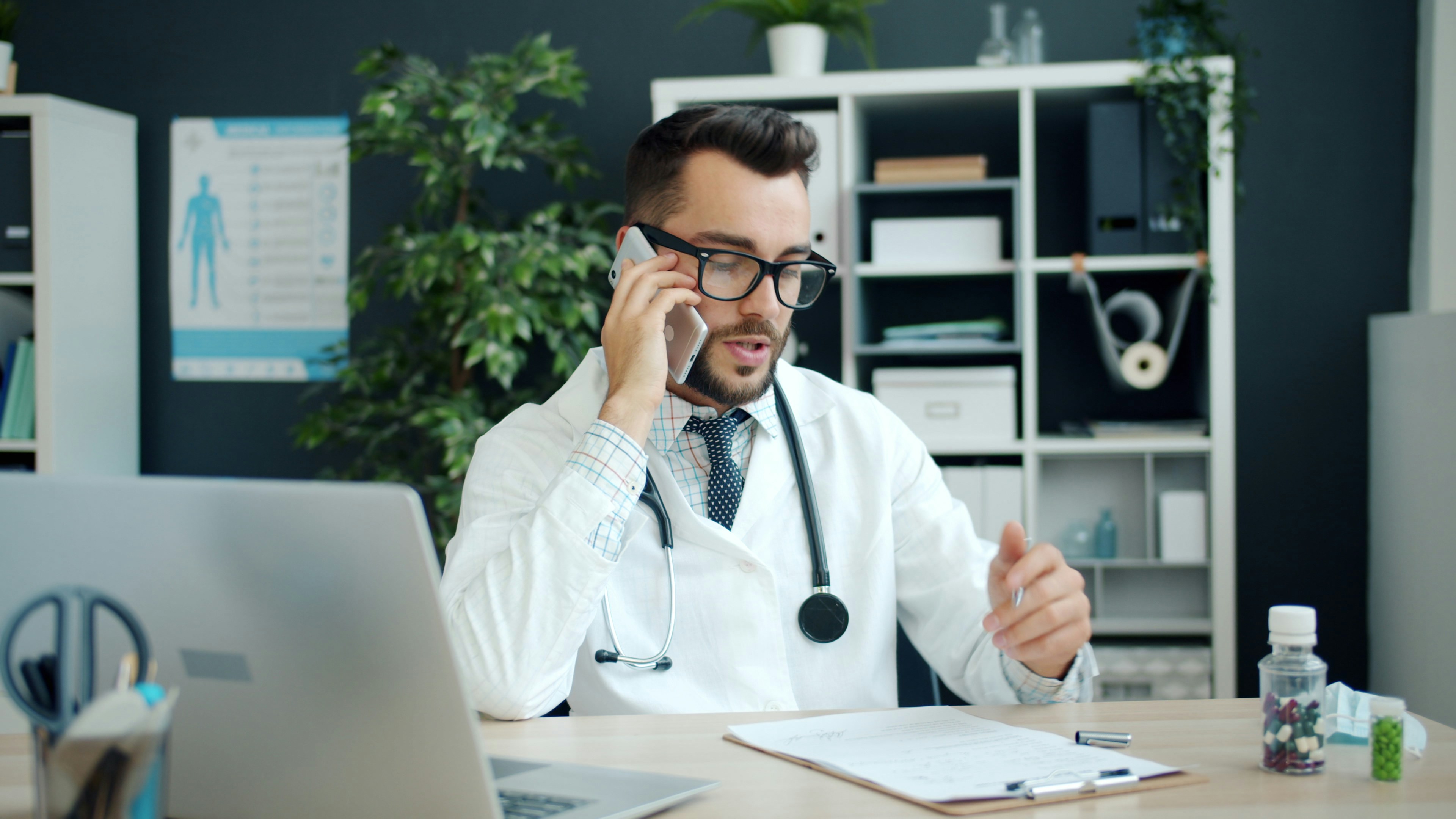 Doctor on the phone at a clinic desk