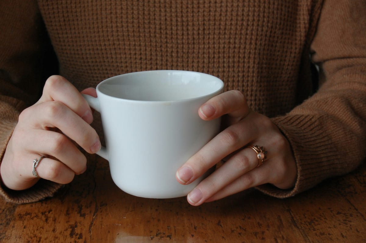 Hands wrapped around a warm mug