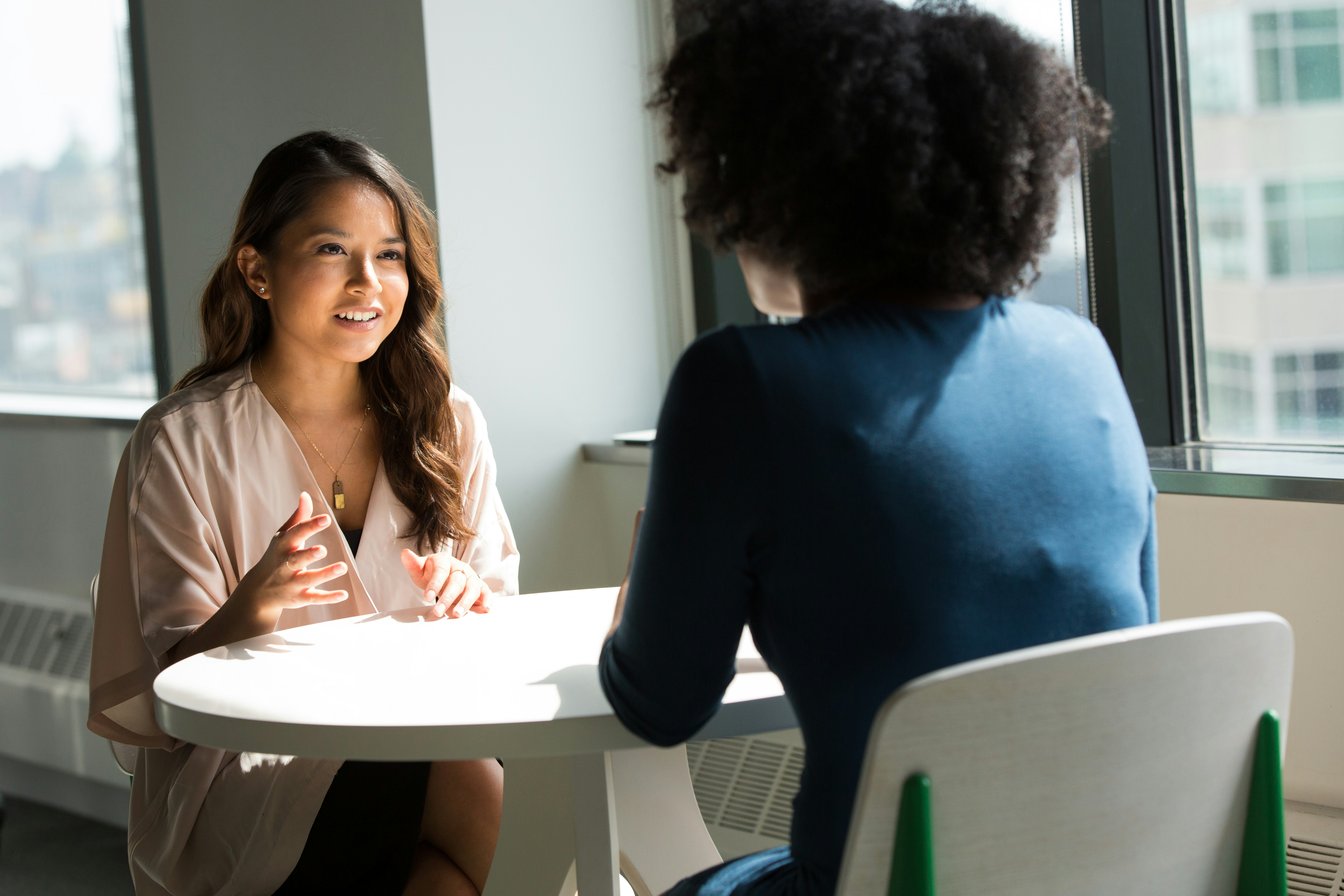 Two women having a conversation at a table